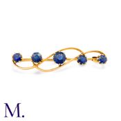 A Sapphire Brooch in yellow gold, set with five round cut sapphires totalling approximately 1.70cts,