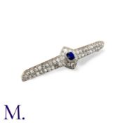 A Sapphire and Diamond Brooch in platinum, set with a central cushion cut sapphire, old cut and rose