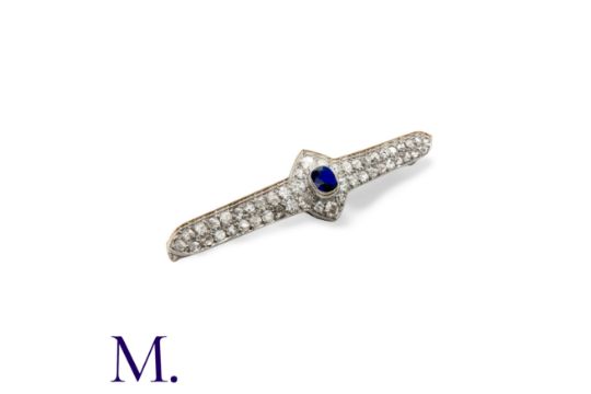 A Sapphire and Diamond Brooch in platinum, set with a central cushion cut sapphire, old cut and rose