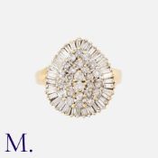 A Pear Shaped Diamond Cluster Ring in 9k yellow gold, set with round cut diamonds and baguette cut