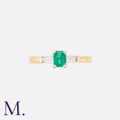 An Emerald And Diamond Three Stone Ring in 18k gold, set with a central step cut emerald, flanked