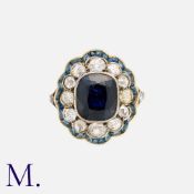An Antique Sapphire & Diamond Ring in 18K yellow gold and silver, set with a cushion-shaped sapphire