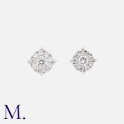 A Pair of Diamond Cluster Studs in 18ct white gold, each set with a single diamond to the centre and