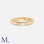 CARTIER. A Diamond Ellipse Band in 18K yellow gold suspension set with a round brilliant cut diamond