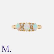 An Antique Opal and Diamond Ring in 18K yellow gold, set with three rich Australian opal cabochons