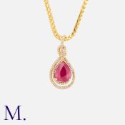 A Ruby And Diamond Pendant And Chain in n14k yellow gold, comprising a pear shaped ruby within a
