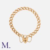 A Curb Bracelet in 9K gold, with heart-shaped padlock fastener and safety chain. Padlock