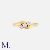 A Diamond Three Stone Ring in 18k yellow gold, set with three round cut diamonds to a twisted shank.