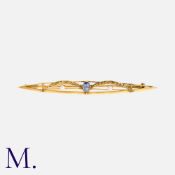 An Art Nouveau Sapphire and Pearl Brooch in 18K yellow gold with festoon gold-work, set to the