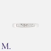 A Diamond Band with 7 channel-set brilliant cut diamonds in 18K white gold. Hallmarked. Size: K