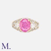 A Pink Sapphire & Diamond Ring in 18K yellow gold, set with an oval-cut pink sapphire (weighing