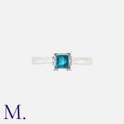 A Blue Diamond Ring in platinum, set with a square-cut blue-coloured diamond (likely irradiated)