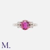 A Ruby And Diamond Ring in white gold, set centrally with an oval ut druby of approximately 1.27cts,