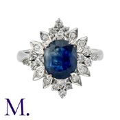 A Sapphire And Diamond Ring in 14k white gold, set with a central oval cut sapphire of approximately