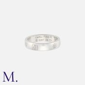 CARTIER. A 'Happy Birthday' Logo Band in platinum. Signed Cartier and serial numbered. Marked