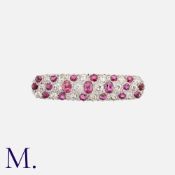 A Ruby And Diamond Brooch in yellow gold and platinum, set with cushion cut rubies and old cut