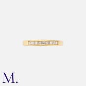 NO RESERVE - A Diamond Band in 18ct yellow gold with nine channel-set princess-cut diamonds weighing