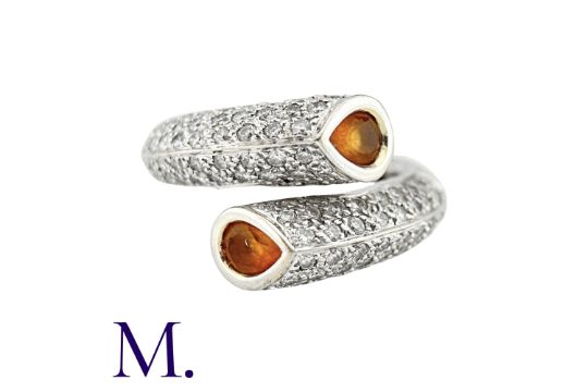 A Citrine And Diamond Crossover Ring in 18k white gold, of crossover design, each end set with a