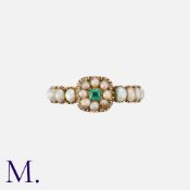A Georgian Emerald And Pearl Cluster Ring in yellow gold, set with a central emerald within a border