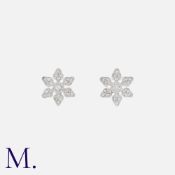 A Pair of Diamond Star Earrings in 18K white gold, set with round cut diamonds. Stamped 750 for 18ct