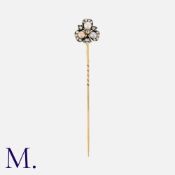 An Antique Pearl And Diamond Stick Pin in yellow gold and silver, the terminal designed as a