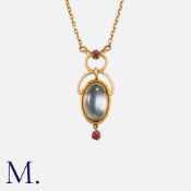 An Edwardian Moonstone and Ruby Pendant Necklace in yellow gold, pendant set to the centre with an