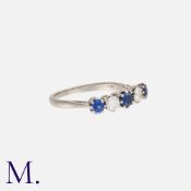 A Sapphire and Diamond 5-Stone Ring in 18K white gold, set with three round cut sapphires and two