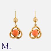 A Pair of Coral Earrings in yellow gold, each set with a cabochon coral to the centre of a triple