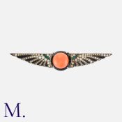 A Coral, Onyx And Paste Brooch in silver, set centrally with a cabochon piece of coral within an