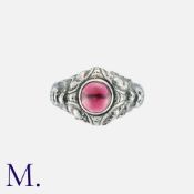An Antique Garnet Ring in silver, the ornate body set with a cabochon garnet. Size: Q Weight: 8.2g.