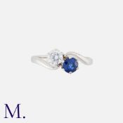 A Sapphire and Diamond Toi et Moi Ring in 18K white gold, set with a round brilliant diamond
