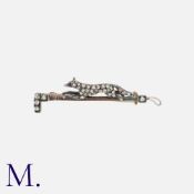 A Diamond-Set Fox And Riding Crop Brooch in silver and gold, comprising a running box on a riding