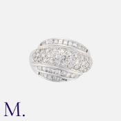 A Diamond Bombe Ring in 18K white gold, pavé set with round cut diamonds across the centre, with