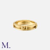 TIFFANY & CO. An Atlas Band in 18K yellow gold, with Roman numerals at cardinal points. Signed