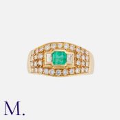 An Emerald And Diamond Ring in 18k yellow gold, set with a principal emerald of approximately 0.