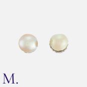 A Pair Of Natural Saltwater Pearl Earrings in platinum, one pearl of 9.7mm the other of 9.1mm.