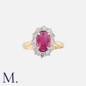 A Fine Burmese Ruby And Diamond Cluster Ring in 18k yellow gold, set with a principal cushion cut