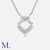 KUTCHINSKY. A Diamond Pendant and Chain in 18K white gold, set with round cut and tapered baguette