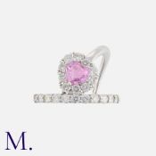 A Pink Sapphire And Diamond Ring in 18k white gold, set with a principle pink sapphire of