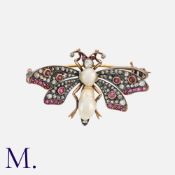 An Antique Pearl, Ruby and Diamond Insect Brooch in 18K yellow gold and silver, set with two large