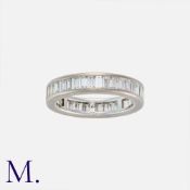 A Baguette Diamond Eternity Ring in 18K white gold set with baguette diamonds in surround. Size: N