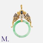 A Sapphire, Diamond and Jade Pendant in yellow gold, set with a cabochon sapphire and round cut