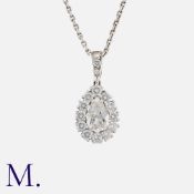 A Diamond Pendant and Chain in 18k white gold, set with a pear cut diamond weighing approximately