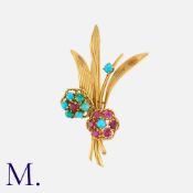BOUCHERON. A Turquoise and Ruby Flower Brooch in 18K yellow gold, set with cabochon turquoise and