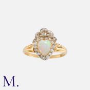 An Opal And Diamond Sweetheart Ring in 18k yellow gold and silver, comprising a heart shaped