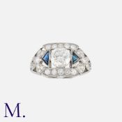 An Art Deco Sapphire and Diamond Ring in platinum, set centrally with a diamond weighing 1.35ct.,