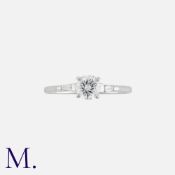 A Diamond Engagement Ring in 18k white gold, set with a principal round cut diamond of approximately