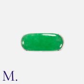 A Jade Ring in 18k white gold, set with a polished piece of jade measuring approximately 21mm X 8.