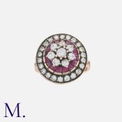 A Ruby and Diamond Ring in rose gold, set with calibre rubies and round cut diamonds weighing