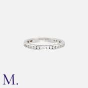 TIFFANY & CO. A Diamond Eternity Ring in platinum, fully-set with round cut diamonds. Size: